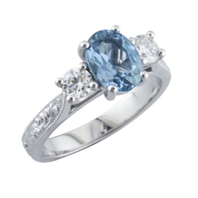 Aquamarine and diamond three stone platinum ring with hand engrave shoulders