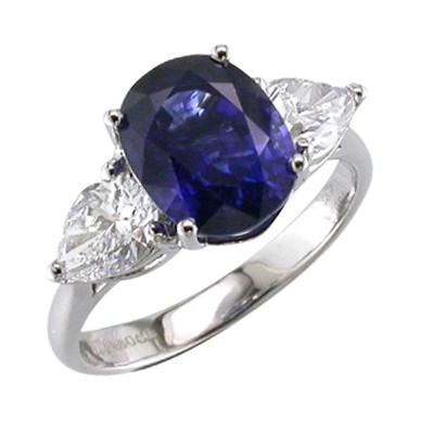 Oval sapphire three stone platinum ring with pear shaped Diamonds