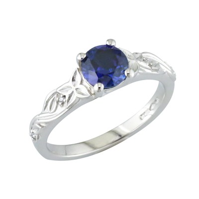 Sapphire and platinum ring with a leaf detailed shoulder