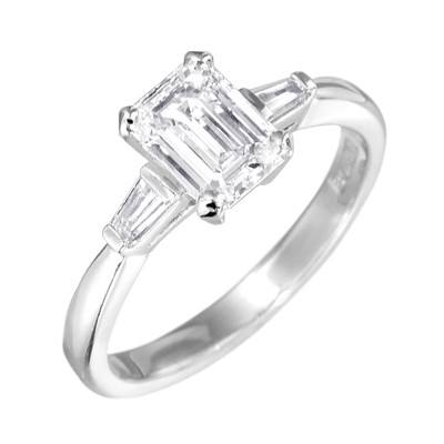 Platinum emerald cut diamond three stone ring with tapered baguettes