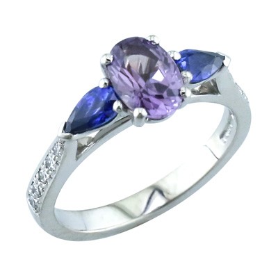 Purple Sapphire and pear shaped Sapphire three stone ring with grain set diamond shoulders