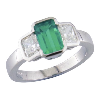 Emerald and emerald cut diamond three stone platinum ring