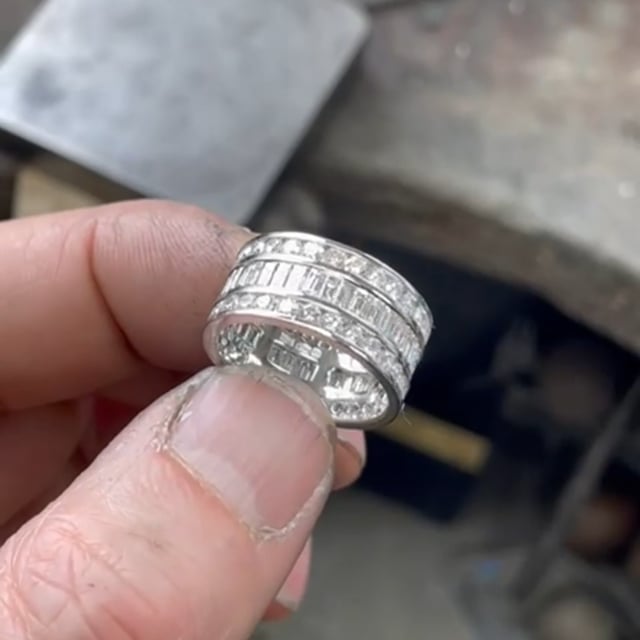 Wide platinum ring with channel set brilliant cut and baguette cut diamonds