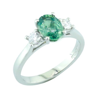 Emerald and diamond three stone platinum ring