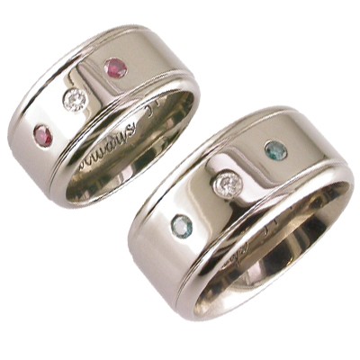 18ct white gold  matching wedding rings,with the couples birthstones set into the bands