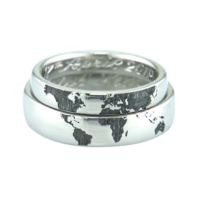 Globe style wedding rings made for a couple that met traveling