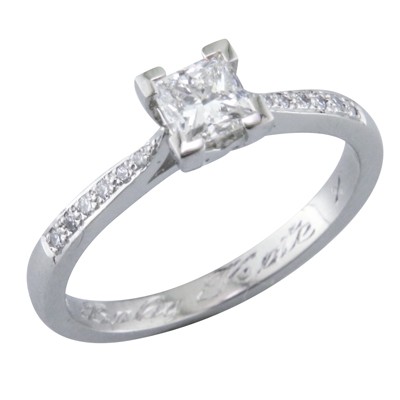 Princess cut single stone diamond ring with grain set diamond shoulders