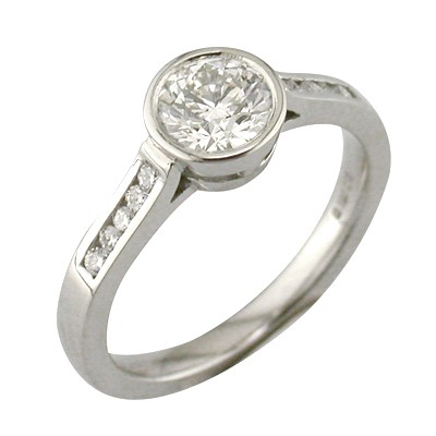 Bezel set single stone ring with channel set shoulders