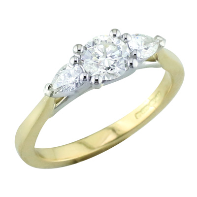 Round and pear shaped diamond three stone ring