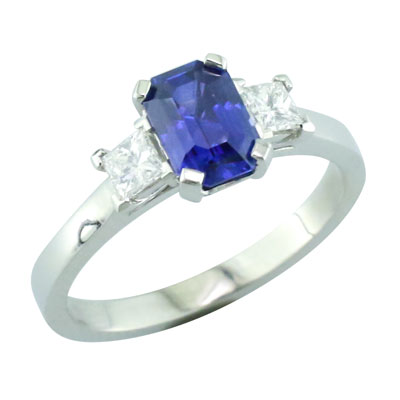 Emerald cut sapphire and princess cut diamond three stone ring