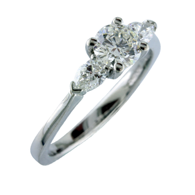 Round and pear shaped diamond  three stone ring