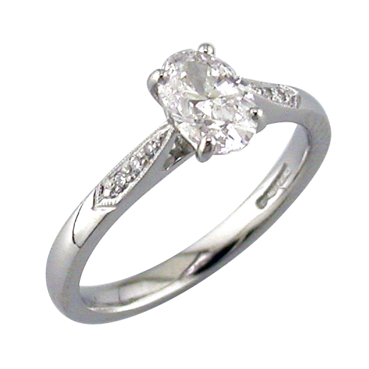 Oval diamond solitaire ring with pave set shoulders