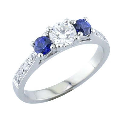 Sapphire and diamond three stone ring with pave set shoulders