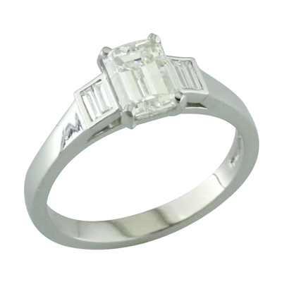 Emerald cut single stone ring with channel set baguette shoulders