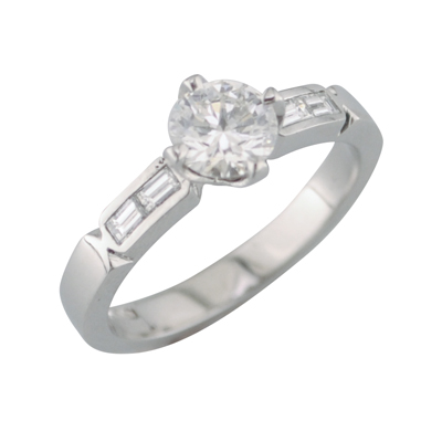 Diamond single stone ring with channel set baguette cut diamonds