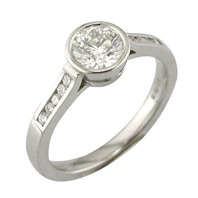 Bezel set, round diamond ring with channel set shoulders
