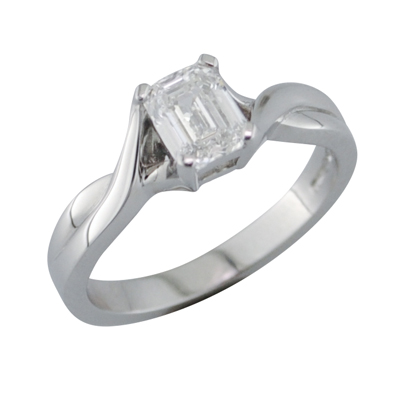 Emerald cut single stone ring with twist style shoulders