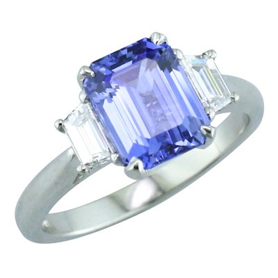 Blue sapphire and trapeze cut diamond three stone platinum ring