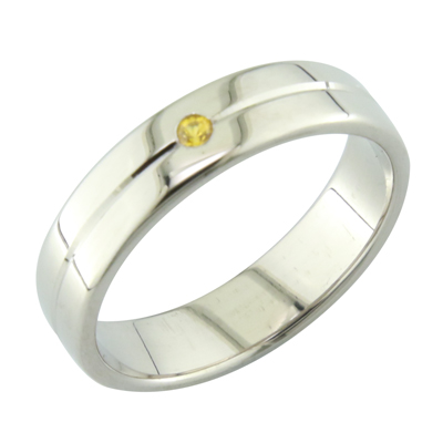 Gent’s platinum band with a flush set yellow sapphire and groove