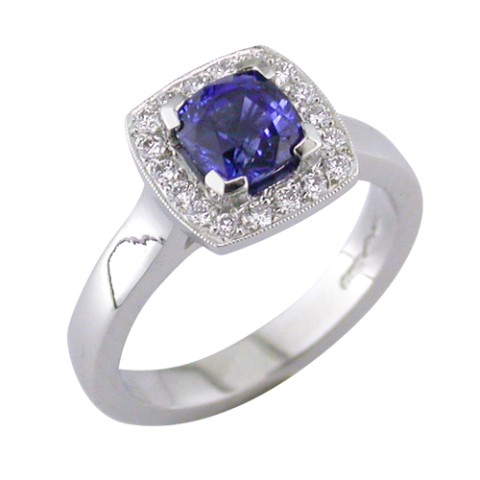 Cushion shaped sapphire halo cluster ring with pave set diamond halo