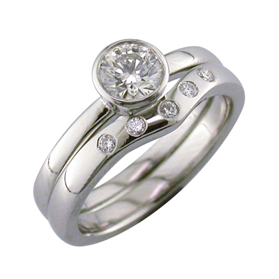 Platinum curved wedding ring with flush set diamonds