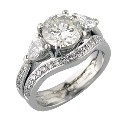 Platinum stone set wedding ring matching the same style as the shoulders of engagement ring