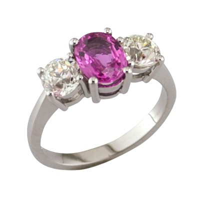 Pink sapphire and diamond three stone platinum ring