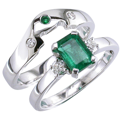 Platinum fitted wedding ring with flush set diamonds and one emerald