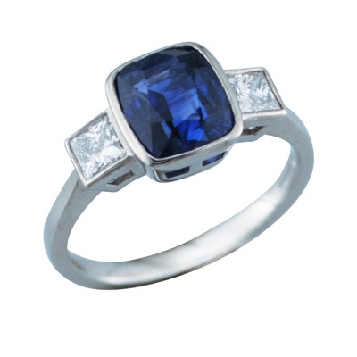 Sapphire three stone ring with rub over set princess cut diamonds